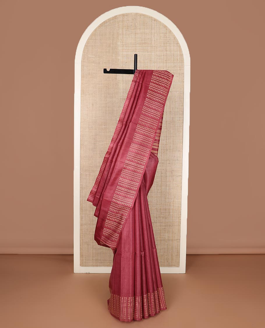 Red plain tussar silk saree, self border and pallu features geometric patterns, and temple motifs