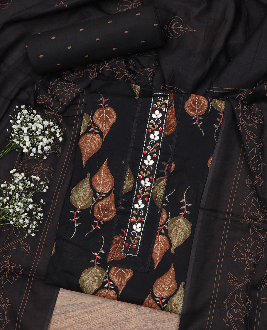 Black material chudidar set, leaf motifs printed with neck embroidered top, matching buttas printed bottom and floral vine printed dupatta