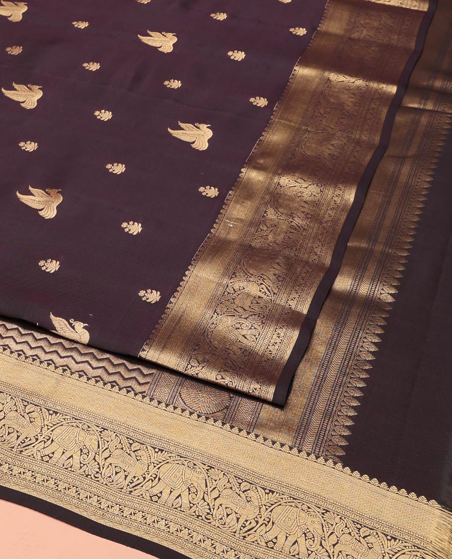 Brown Vasundhara Lite-Silk Mix Saree, Delicately Woven with Zari Buttas on Its Body, Highlighted by a Zari Border of Mayil Kann, Muthu, Yaanai, Kuthirai, and Lavangam Designs, Gracefully Embellished Pallu, and Paired with a Matching Blouse