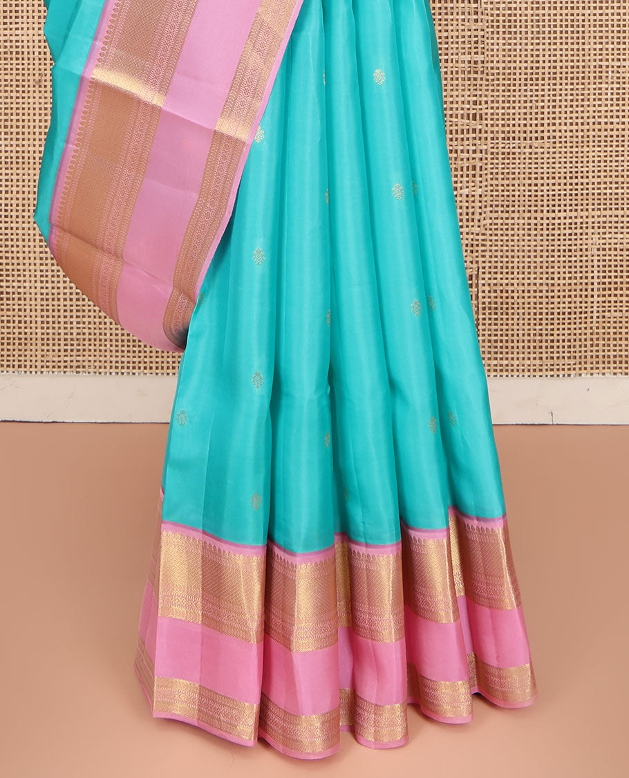 Blue Vasundhara Lite Silk Mix Saree, Adorned with Zari Buttas on Its Body, Complemented by a Contrast Retti Pettu Border of Thilakam, Banaras, Mayil Kann, Muthu, and Kamalam Designs, Pallu Steeped with Feather Motifs, and Paired with a Contrast Blouse