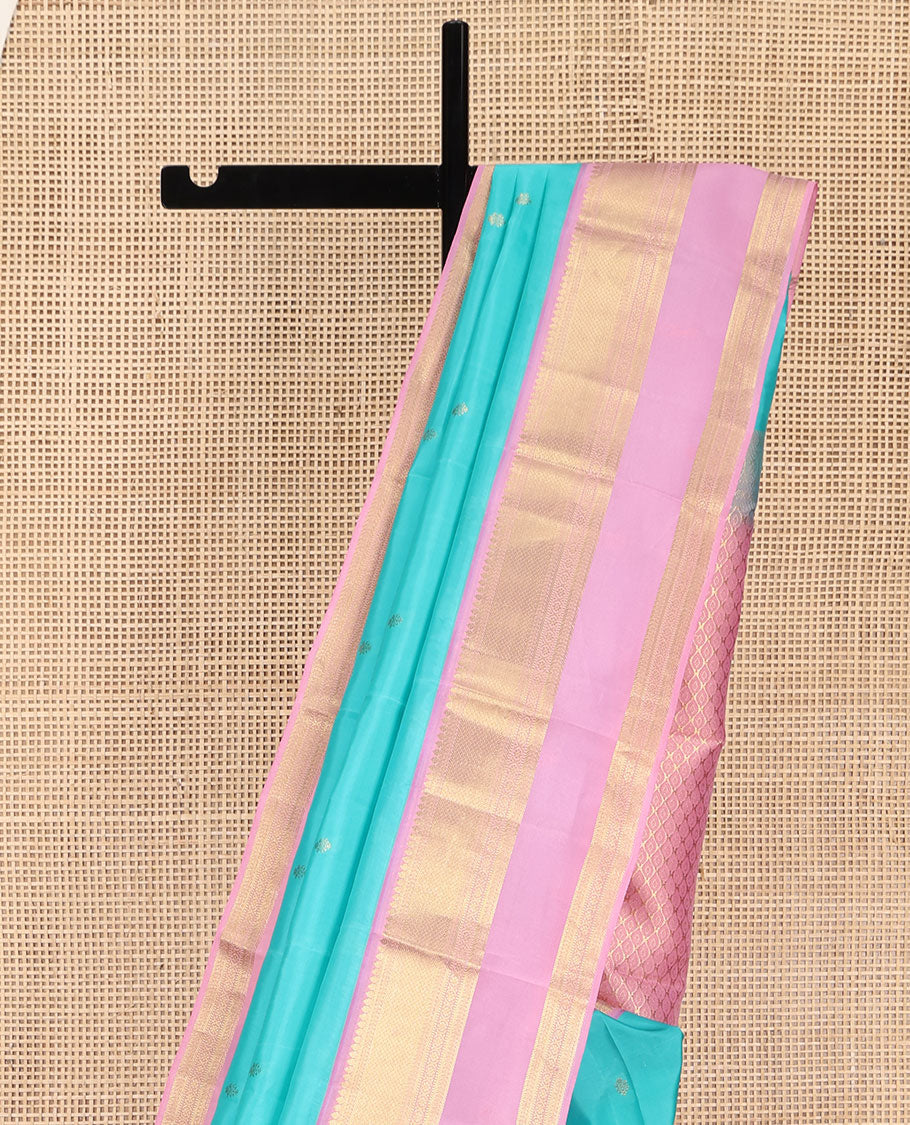 Blue Vasundhara Lite Silk Mix Saree, Adorned with Zari Buttas on Its Body, Complemented by a Contrast Retti Pettu Border of Thilakam, Banaras, Mayil Kann, Muthu, and Kamalam Designs, Pallu Steeped with Feather Motifs, and Paired with a Contrast Blouse