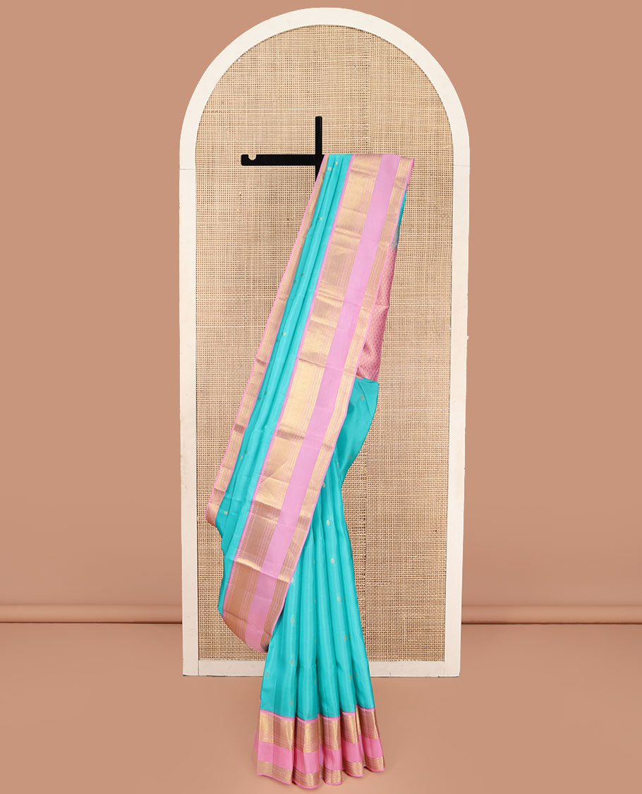 Blue Vasundhara Lite Silk Mix Saree, Adorned with Zari Buttas on Its Body, Complemented by a Contrast Retti Pettu Border of Thilakam, Banaras, Mayil Kann, Muthu, and Kamalam Designs, Pallu Steeped with Feather Motifs, and Paired with a Contrast Blouse