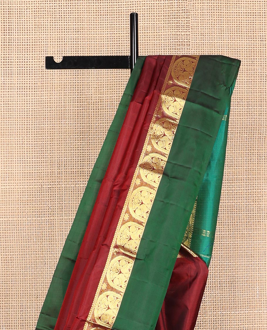 Maroon zari buttas Kanchipuram silk saree, contrast border of thilakam mokku, and mayil designs, and zari design pallu