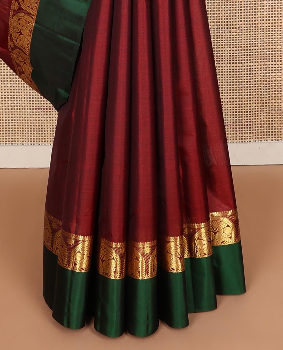 Maroon zari buttas Kanchipuram silk saree, contrast border of thilakam mokku, and mayil designs, and zari design pallu
