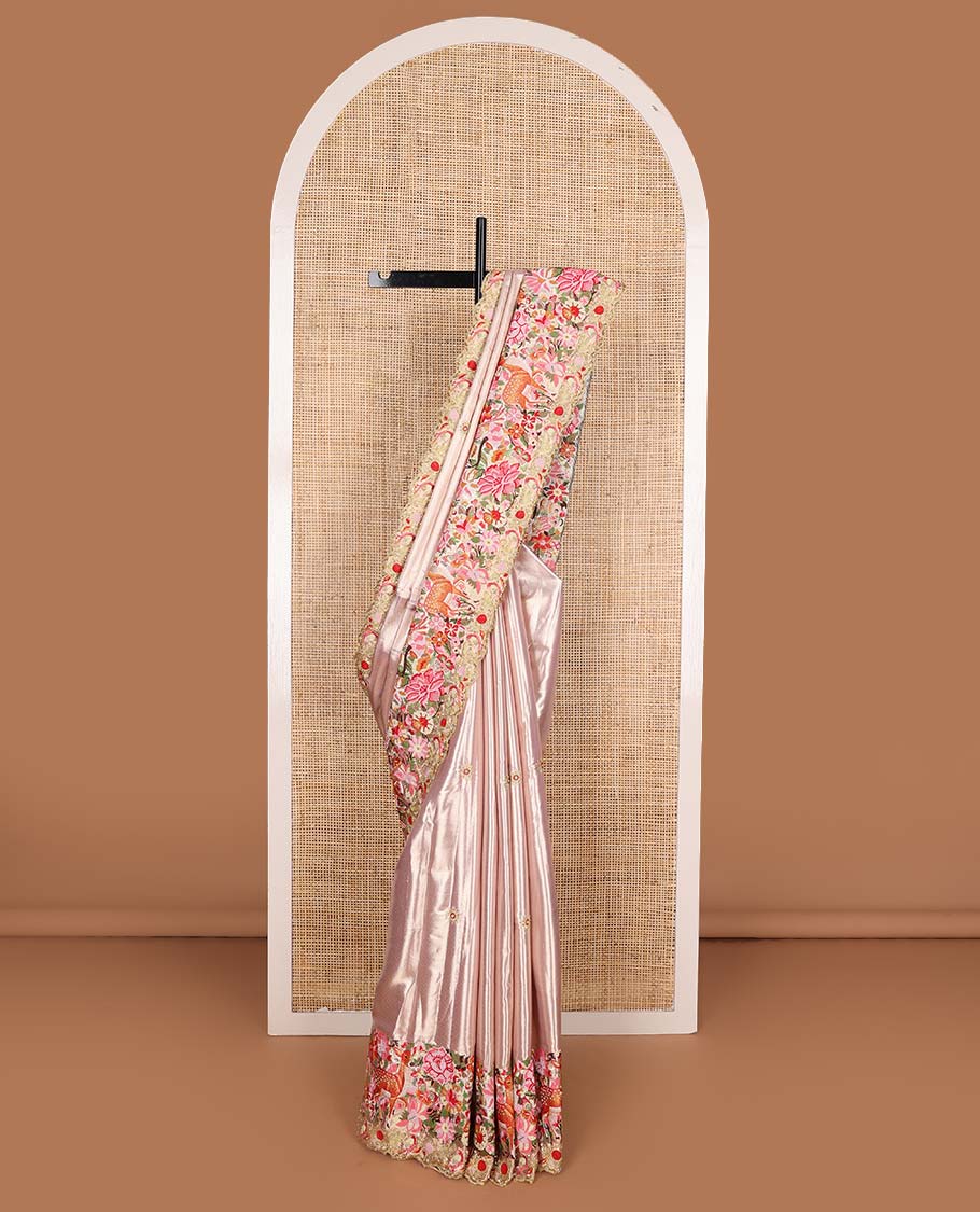 Pink jacquard with embroidered tissue silk saree, colorful jungle-theme flora-fauna mixed embroidered scallop border, and geometric patterned pallu