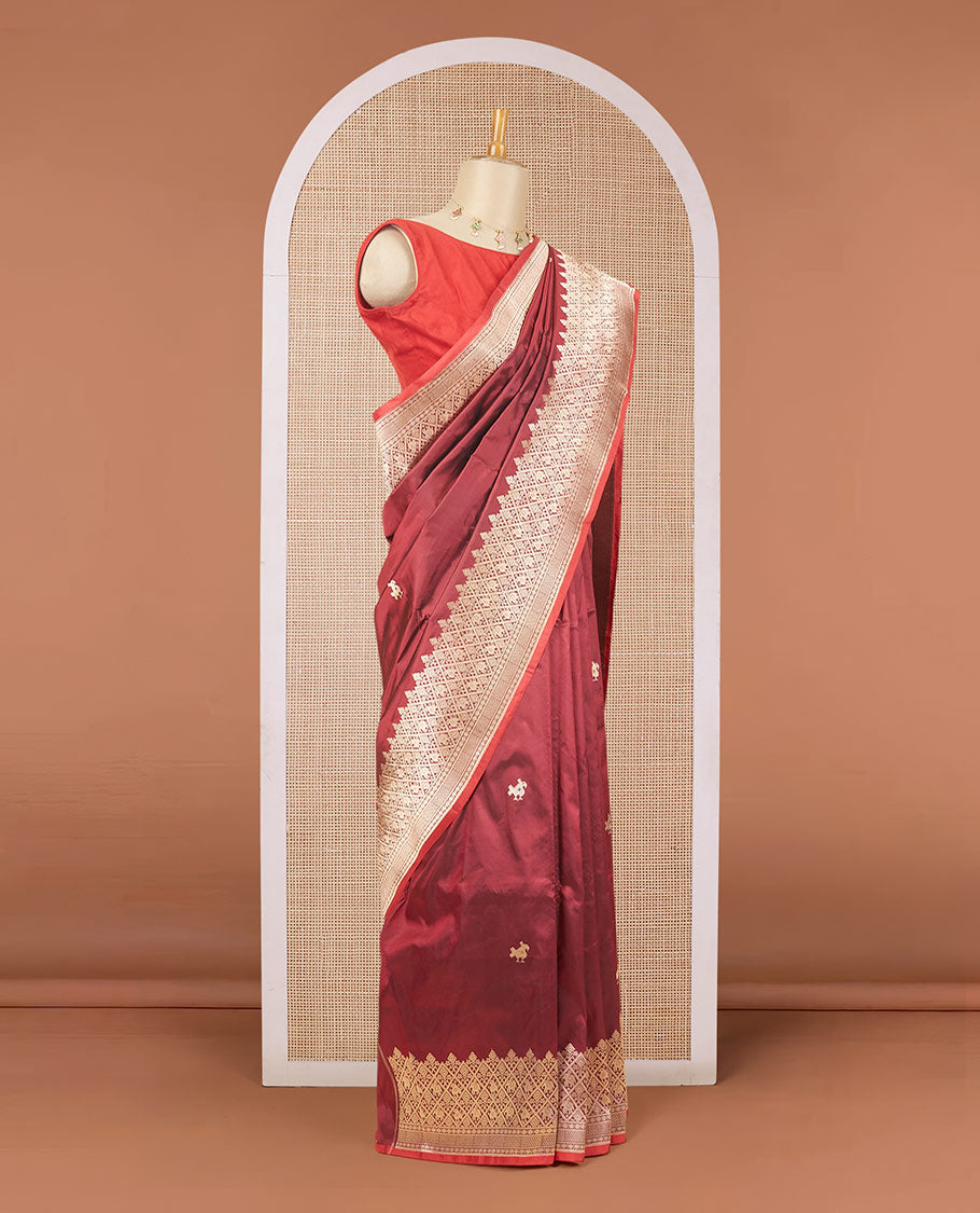 Maroon katan silk saree with patola-style zari buttas, zari border & pallu of patola-style animal motifs enclosed checks