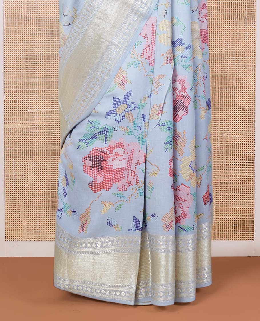 Blue printed chiniya silk saree with colorful floral motifs, traditional zari design border