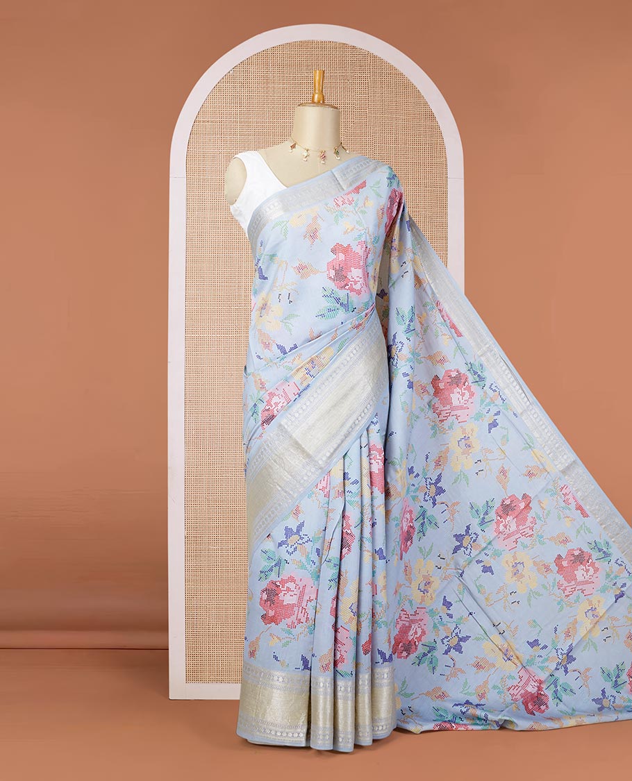 Blue printed chiniya silk saree with colorful floral motifs, traditional zari design border
