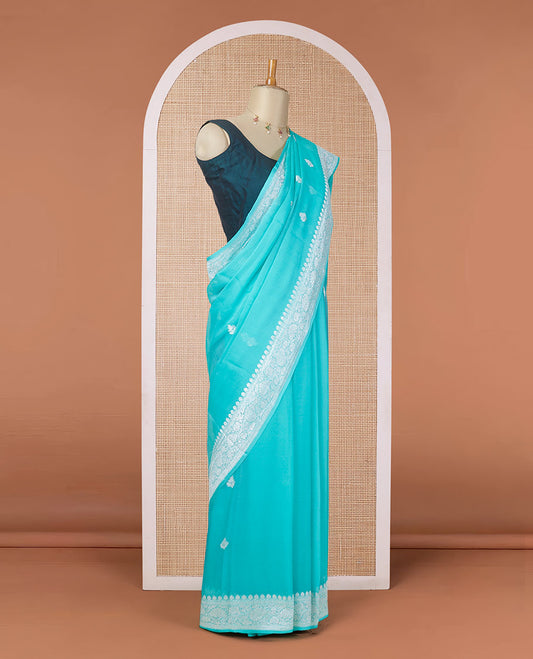 Turquoise banarasi georgette saree with zari buttas, floral creeper zari border & pallu of paisleys