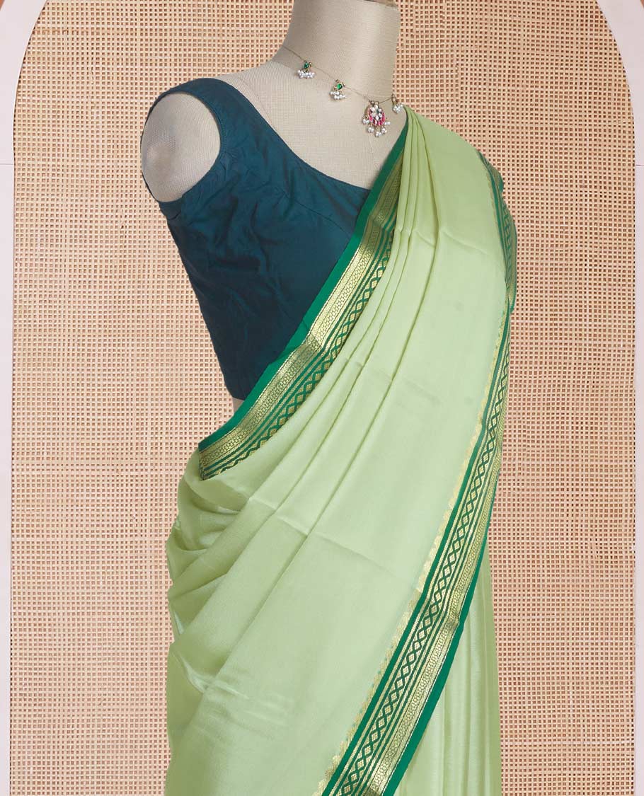 Tea green color plain Mysore silk saree with contrast geometric zari design borders and pallu of zari seer lines