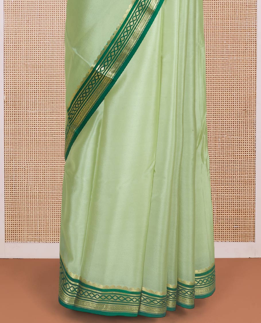 Tea green color plain Mysore silk saree with contrast geometric zari design borders and pallu of zari seer lines