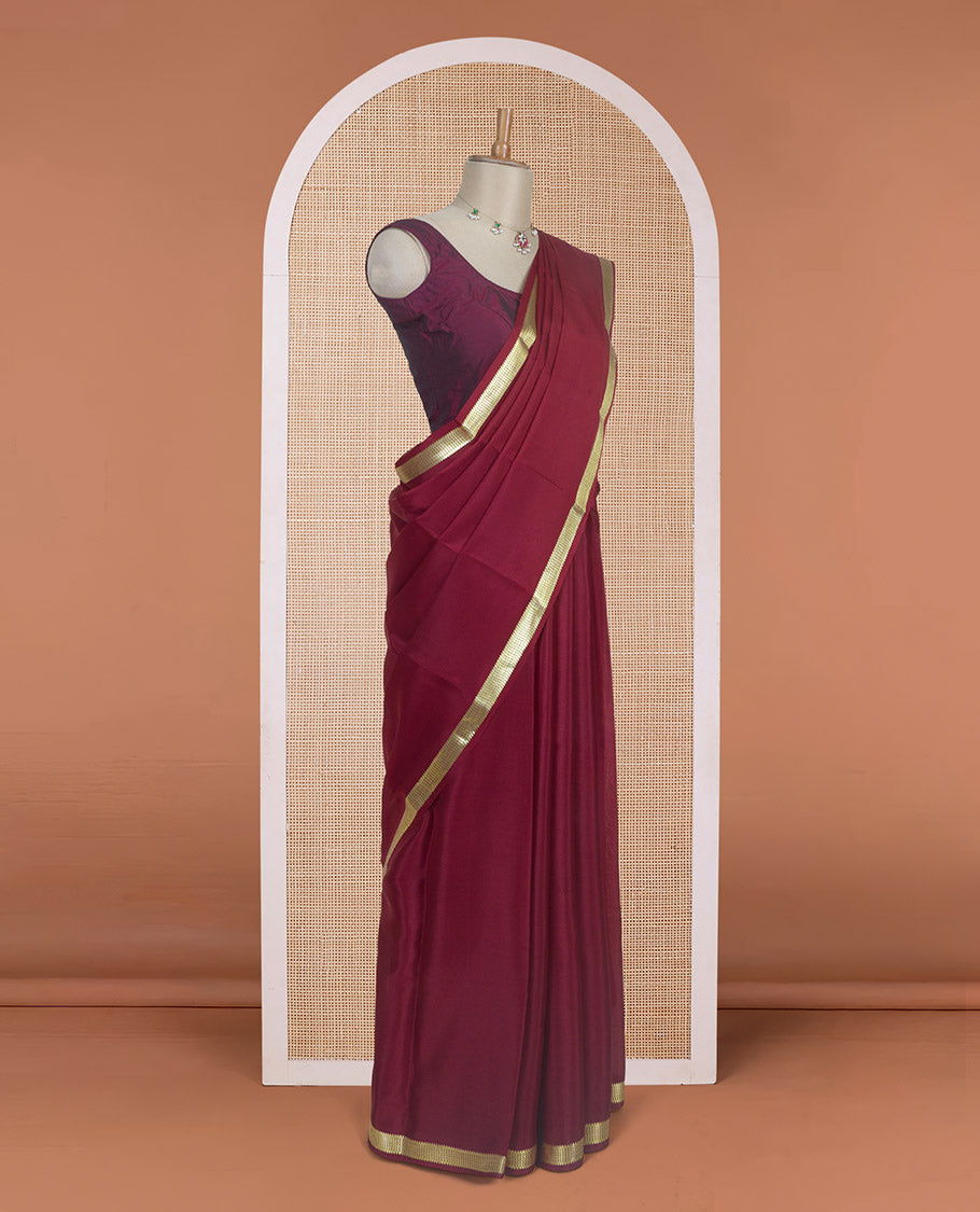 Maroon plain design Mysore silk saree with traditional zari design borders, and zari striped pallu