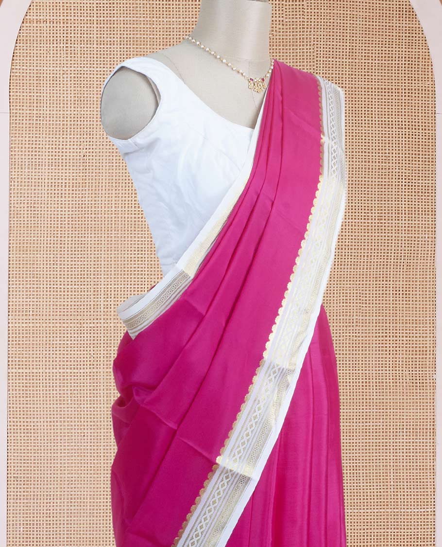 Dark pink plain body Mysore silk saree, contrast border adorned with traditional motifs in zari, and pallu of zari stripes
