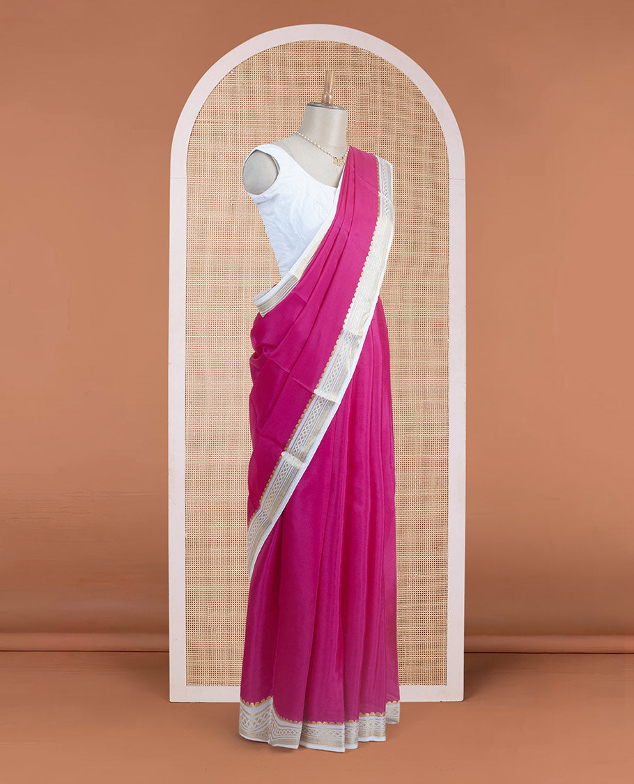 Dark pink plain body Mysore silk saree, contrast border adorned with traditional motifs in zari, and pallu of zari stripes