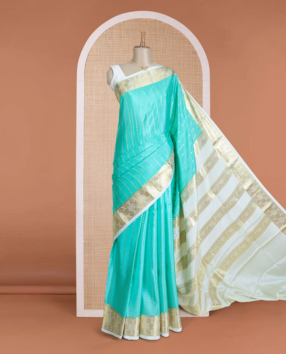 Turquoise zari buttas Mysore silk saree, contrast peacock and chakram zari border, and pallu steeped with traditional zari designs