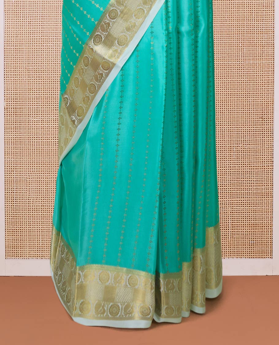 Turquoise zari buttas Mysore silk saree, contrast peacock and chakram zari border, and pallu steeped with traditional zari designs