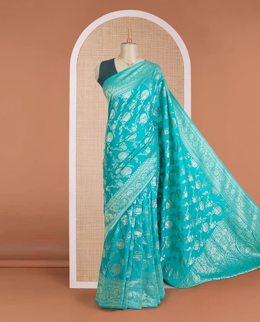 Green floral jaal jacquard fancy crepe saree, floral creeper zari border, and pallu of paisley jaal design