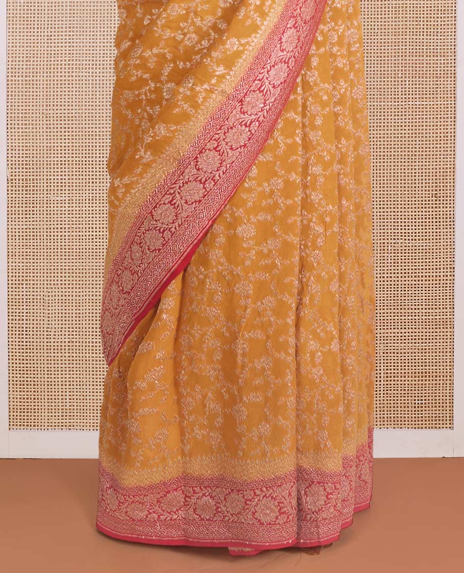 Yellow floral jaal jacquard banarasi georgette saree, contrast floral creeper zari border, and pallu of floral jaal design