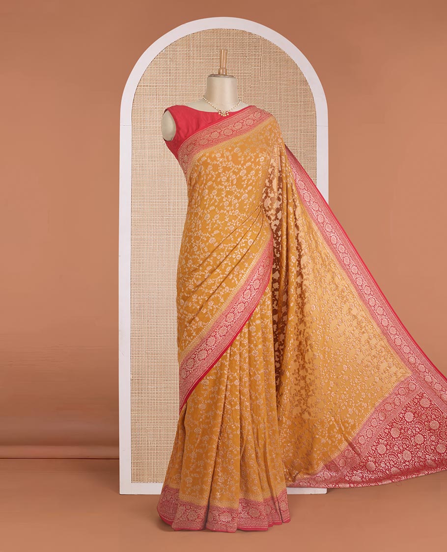 Yellow floral jaal jacquard banarasi georgette saree, contrast floral creeper zari border, and pallu of floral jaal design