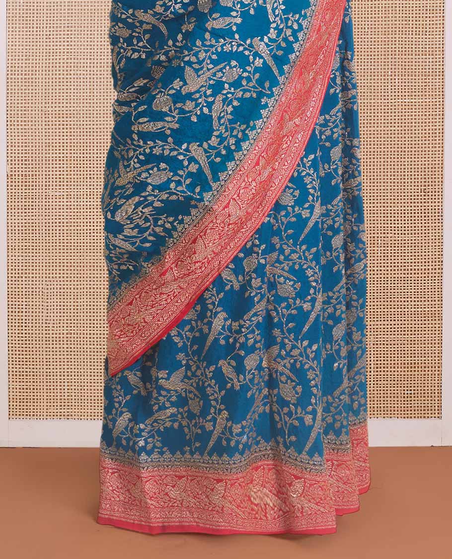 Blue floral and bird jaal jacquard banaras crepe saree, contrast floral and bird jaal zari border, and pallu of Mughal style motifs