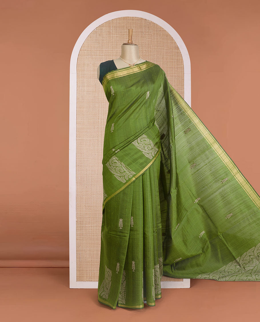 Green dupion silk saree with floral buttas, thin zari piping border, and floral vine pallu