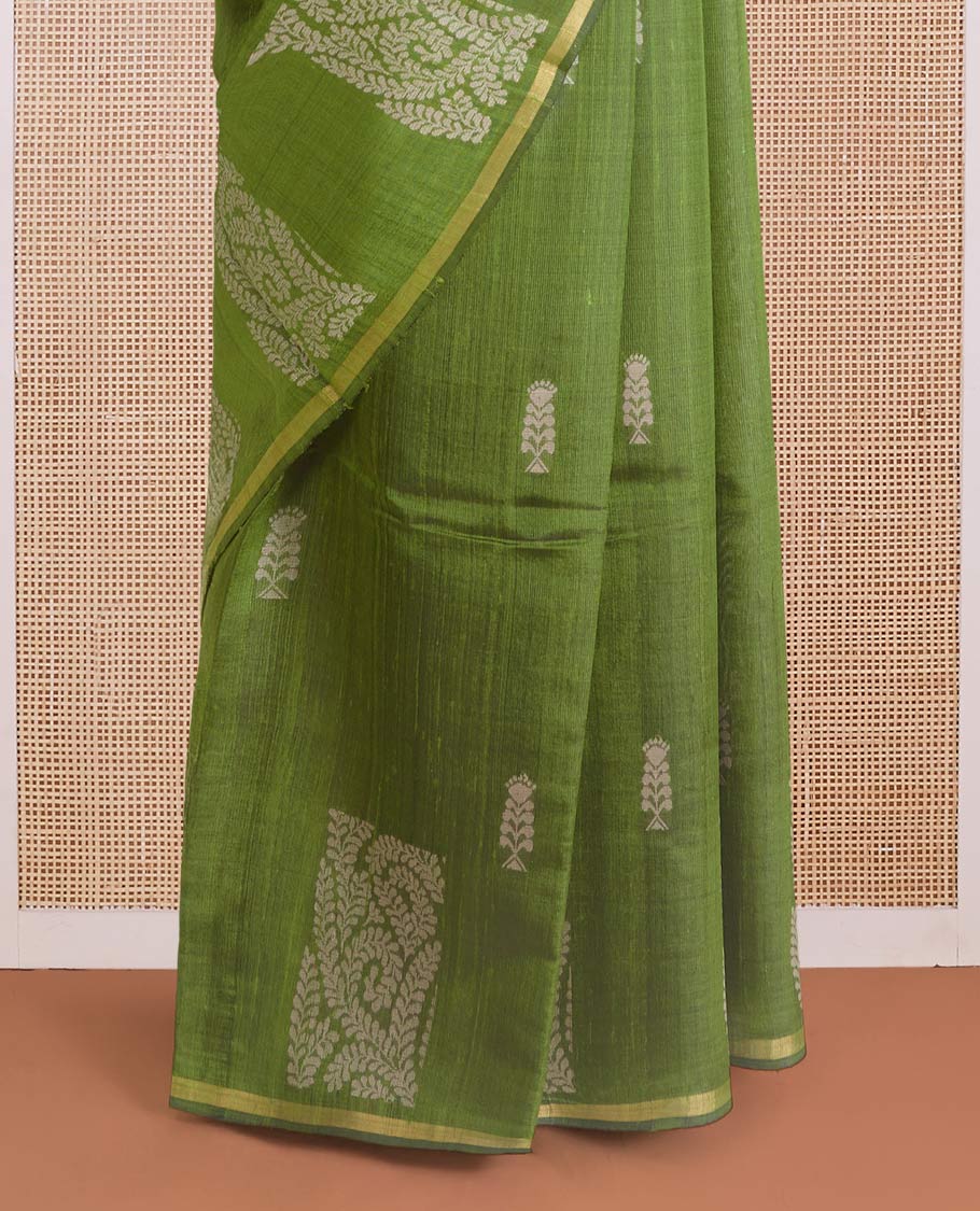 Green dupion silk saree with floral buttas, thin zari piping border, and floral vine pallu