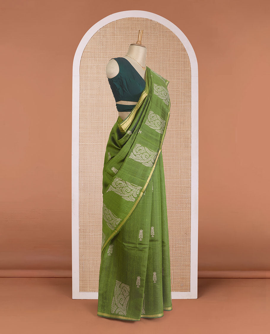 Green dupion silk saree with floral buttas, thin zari piping border, and floral vine pallu