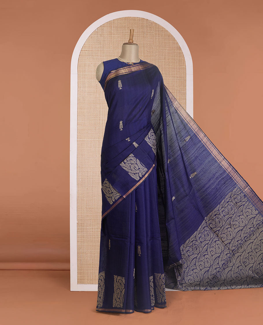 Navy blue dupion silk saree with floral buttas, thin zari piping border, and floral vine pallu