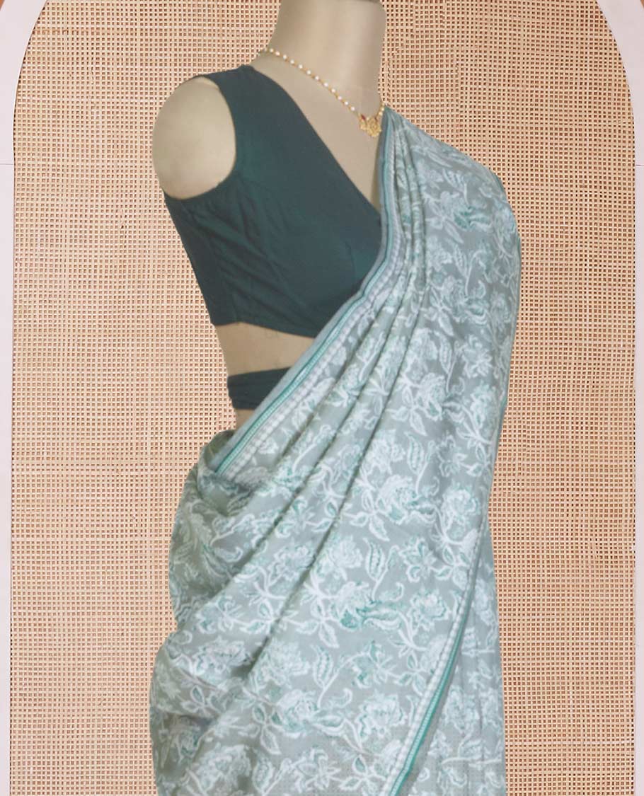 Pastel green floral vine printed silk saree, geometric printed border, and geometric printed pallu