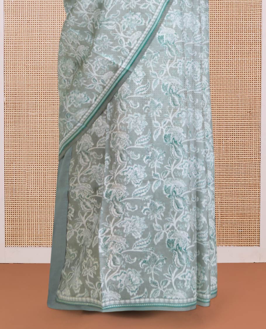 Pastel green floral vine printed silk saree, geometric printed border, and geometric printed pallu