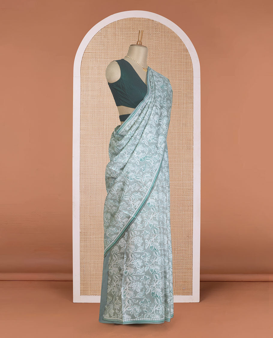 Pastel green floral vine printed silk saree, geometric printed border, and geometric printed pallu