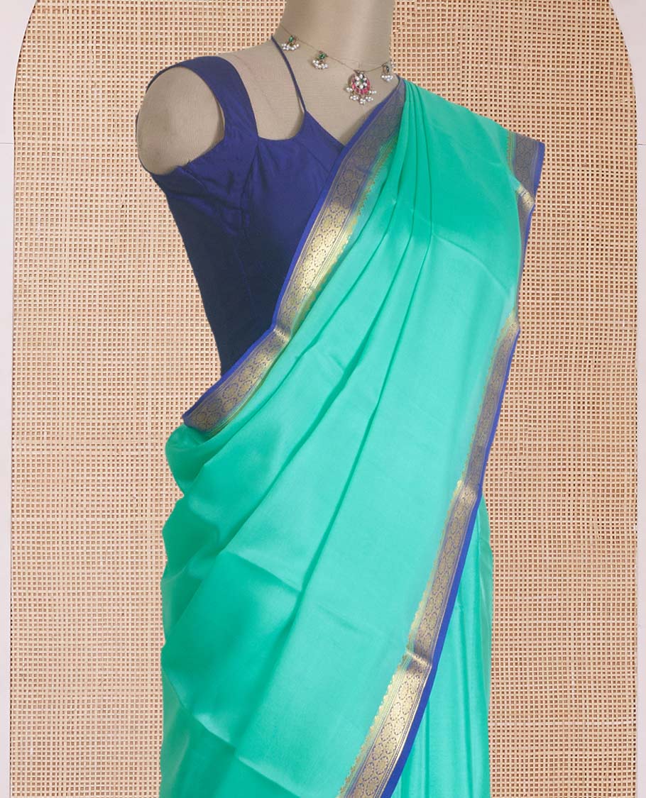 Seafoam green plain Mysore silk saree, contrast traditional zari border, and zari striped pallu