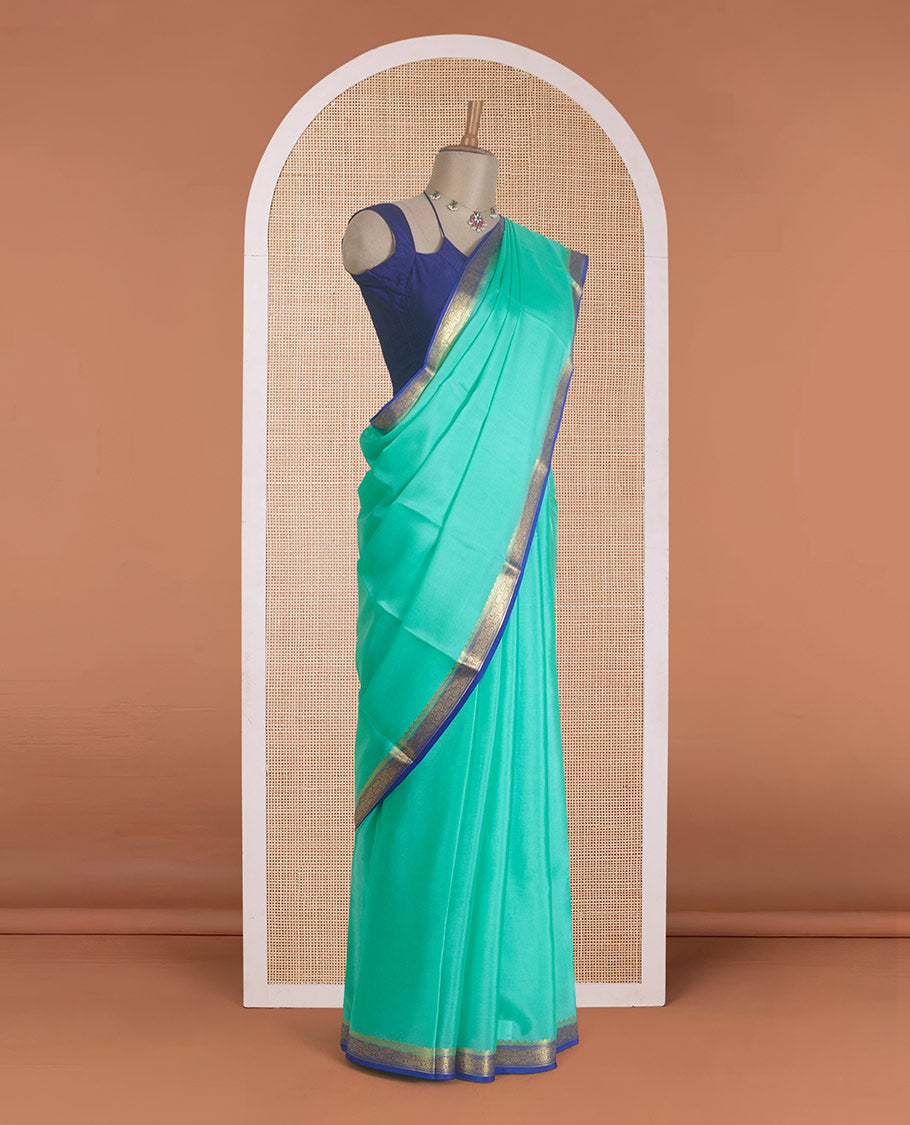 Seafoam green plain Mysore silk saree, contrast traditional zari border, and zari striped pallu