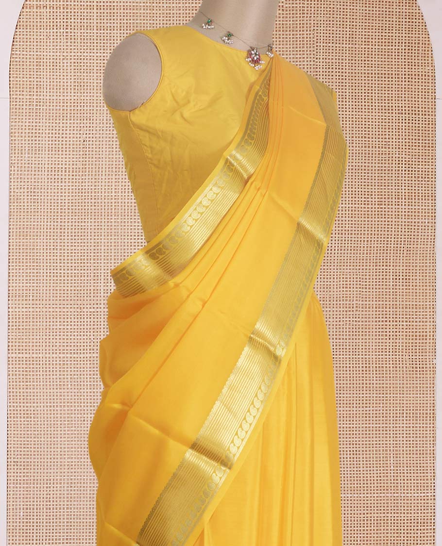 Yellow plain Mysore silk saree, traditional zari design steeped border, and zari striped pallu