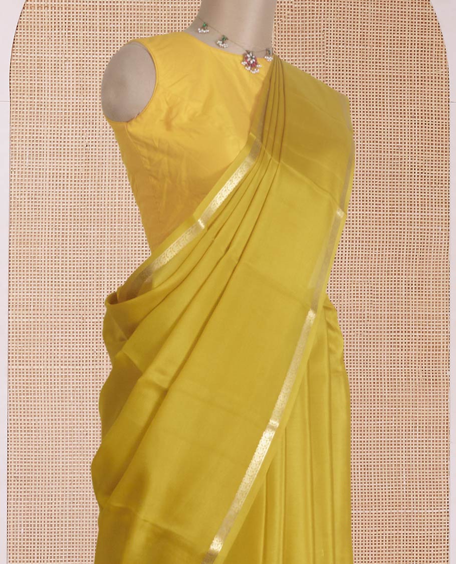 Yellow plain Mysore silk saree, traditional zari border, and zari striped pallu