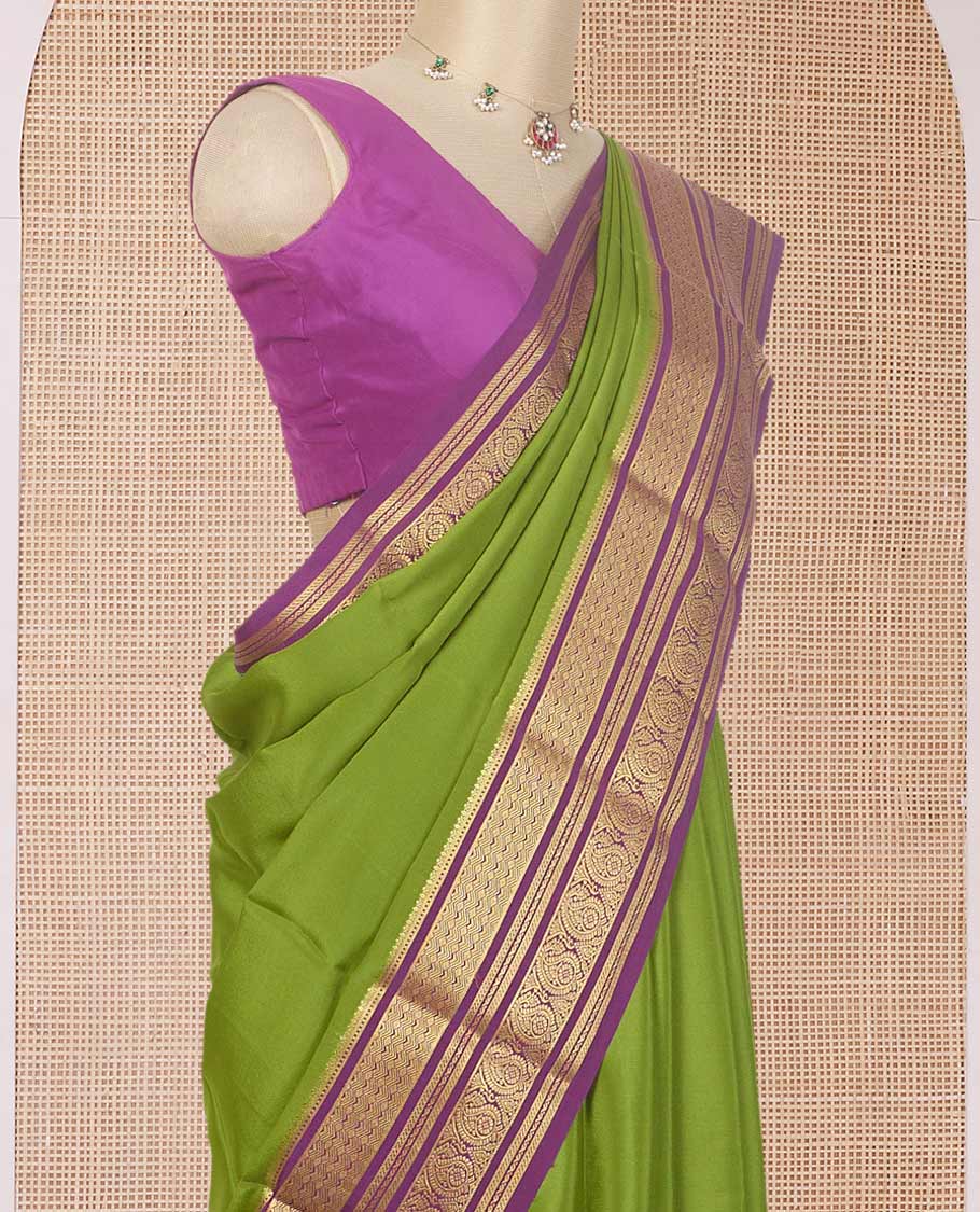 Green plain Mysore silk saree, contrast traditional zari border of paisleys, and zari striped pallu