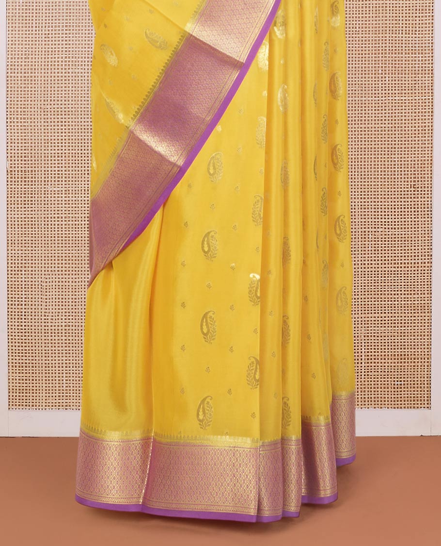 Yellow paisley buttas Mysore silk saree, contrast traditional zari border, and jaal design pallu