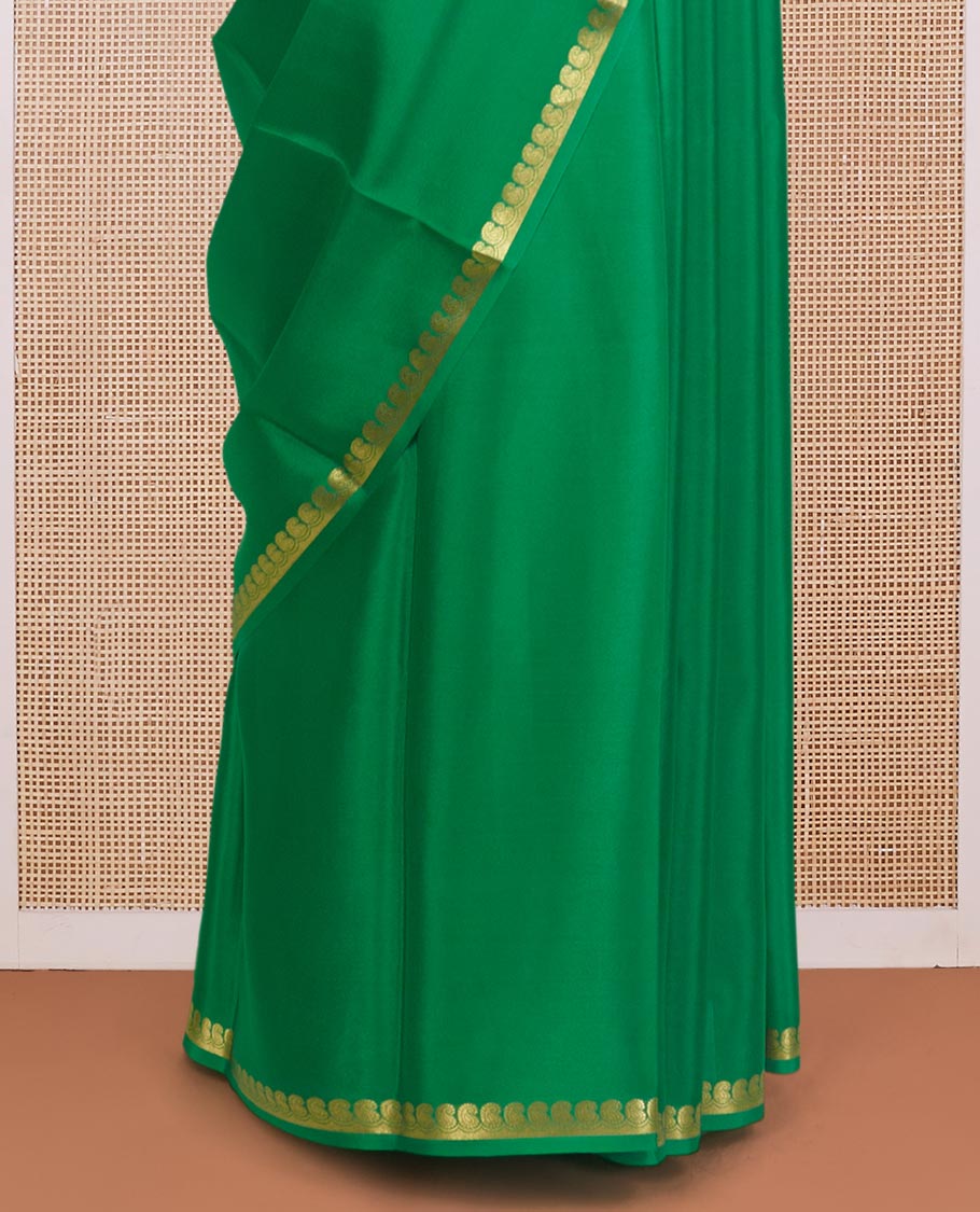 Green plain Mysore silk saree, zari border of paisleys, and zari striped pallu