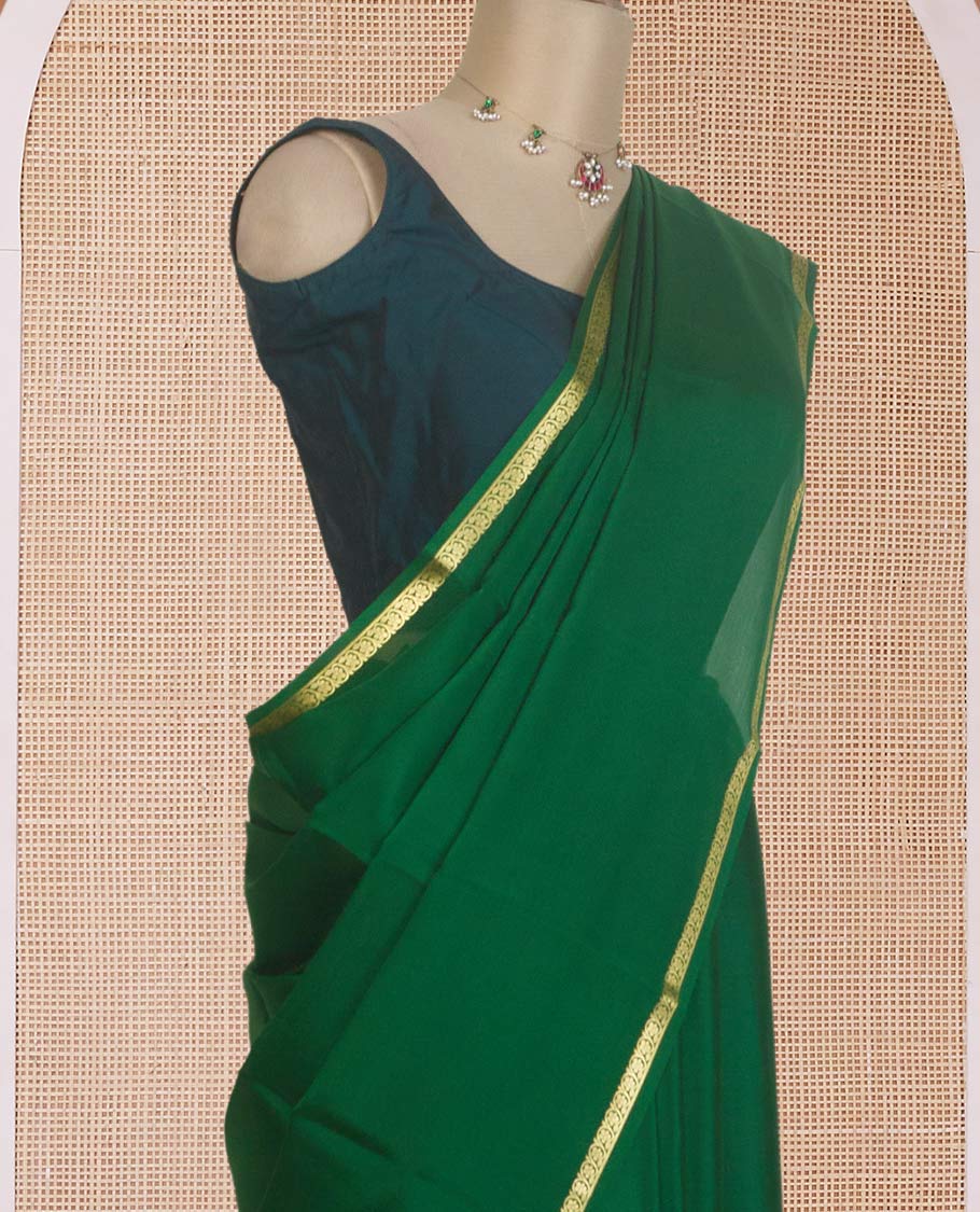 Dark green plain Mysore silk saree, zari border of floral creeper designs, and zari striped pallu
