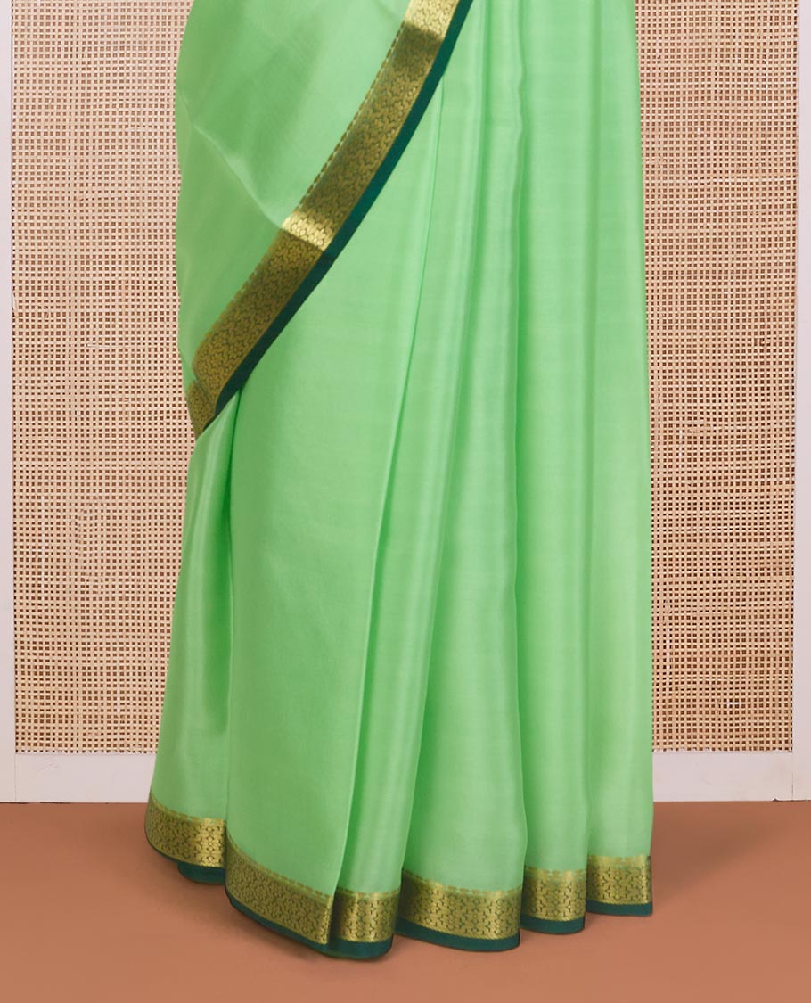 Pista green plain Mysore silk saree, contrast zari border of traditional designs, and zari striped pallu