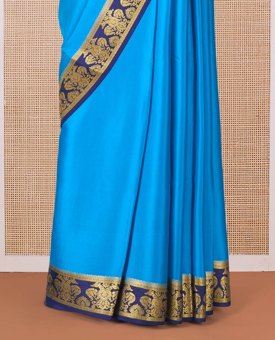 Blue plain Mysore silk saree, contrast two-headed eagle border, and pallu of traditional designs