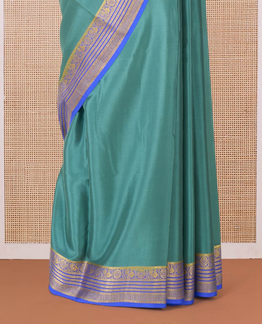 Green plain Mysore silk saree, contrast traditional zari border of Peacock and chakram and pallu of traditional designs