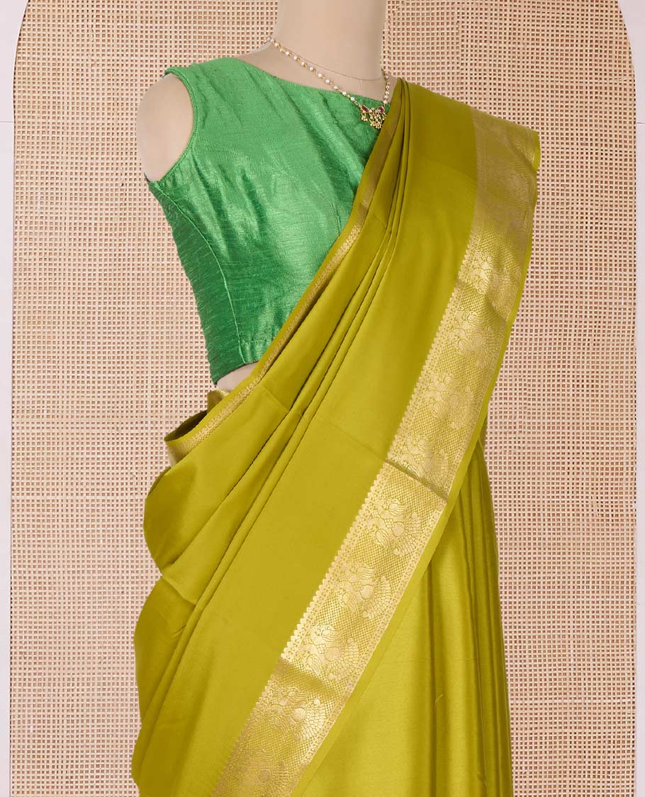 Green plain Mysore silk saree, zari border of two-headed eagle motifs, and pallu of zari designs