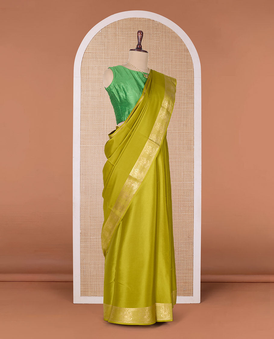 Green plain Mysore silk saree, zari border of two-headed eagle motifs, and pallu of zari designs