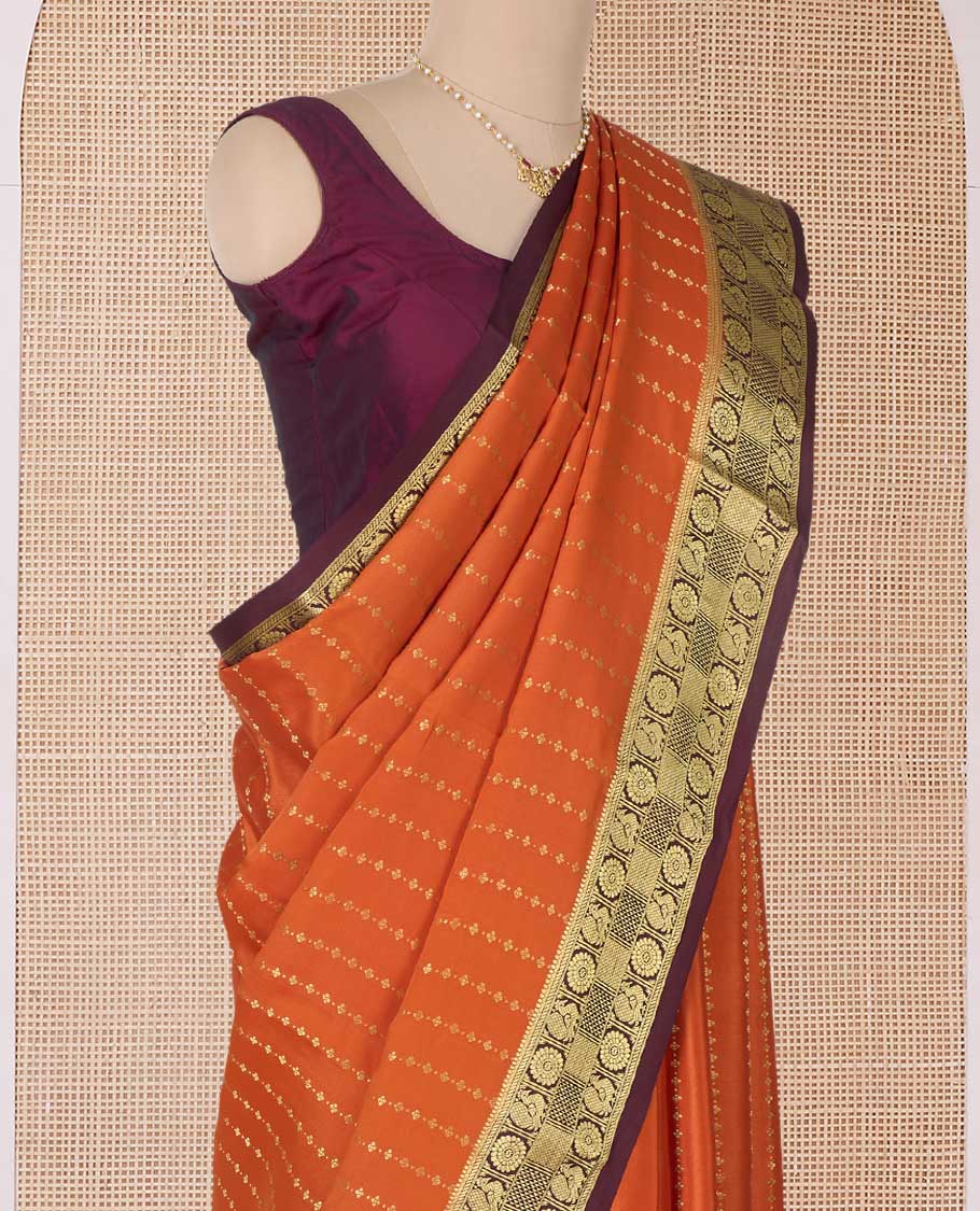 Orange zari buttas Mysore silk saree, contrast peacock chakram zari buttas border, and pallu steeped with traditional designs