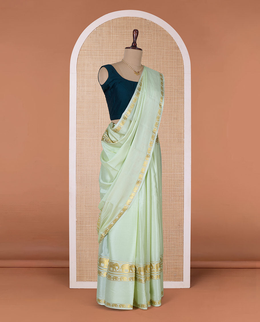Pale green plain Mysore silk saree, rettai pettu border of elephant motifs, and pallu of stripes in zari