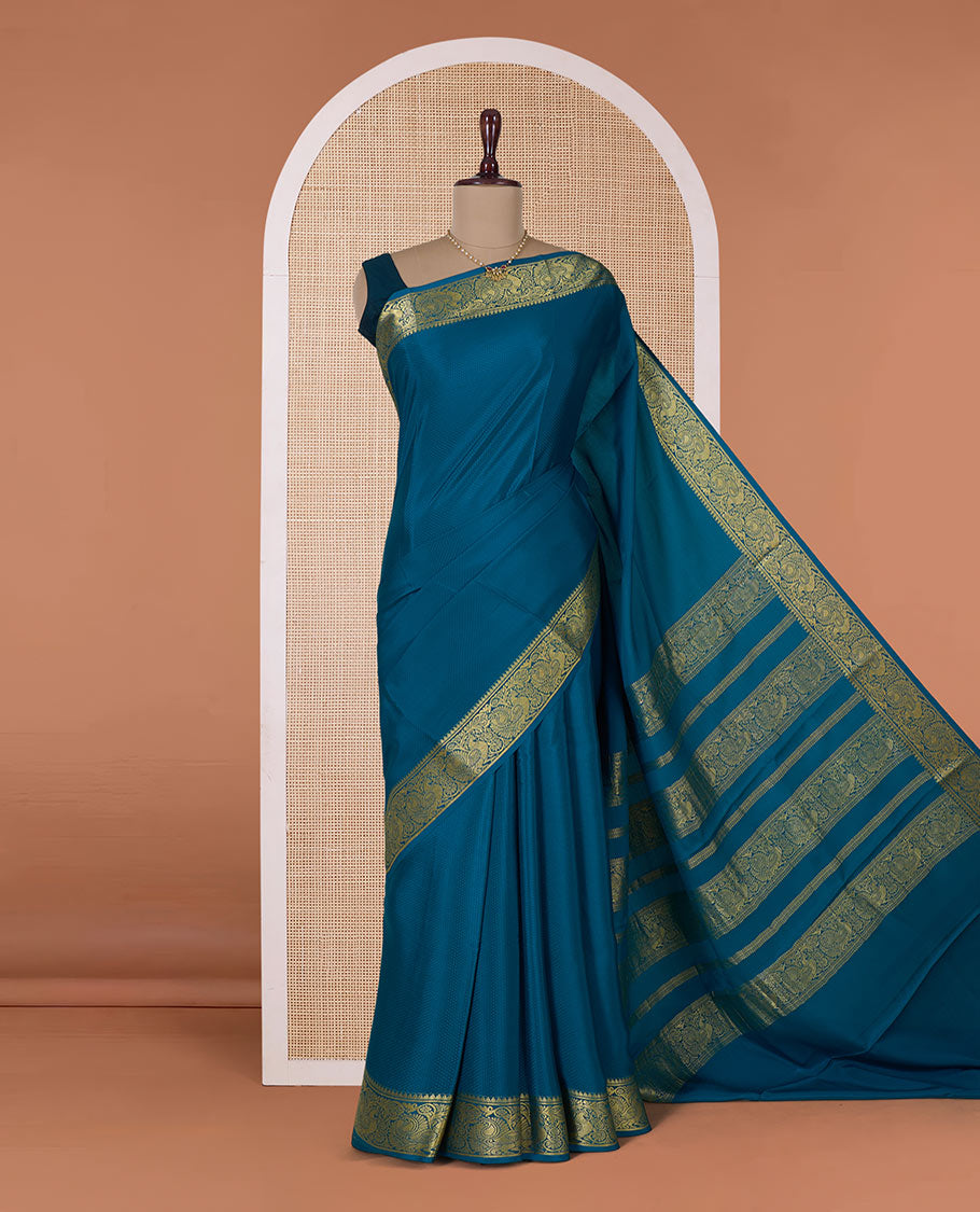 Peacock color embossed Mysore silk saree, traditional peacock motifs zari woven border, and pallu of traditional designs