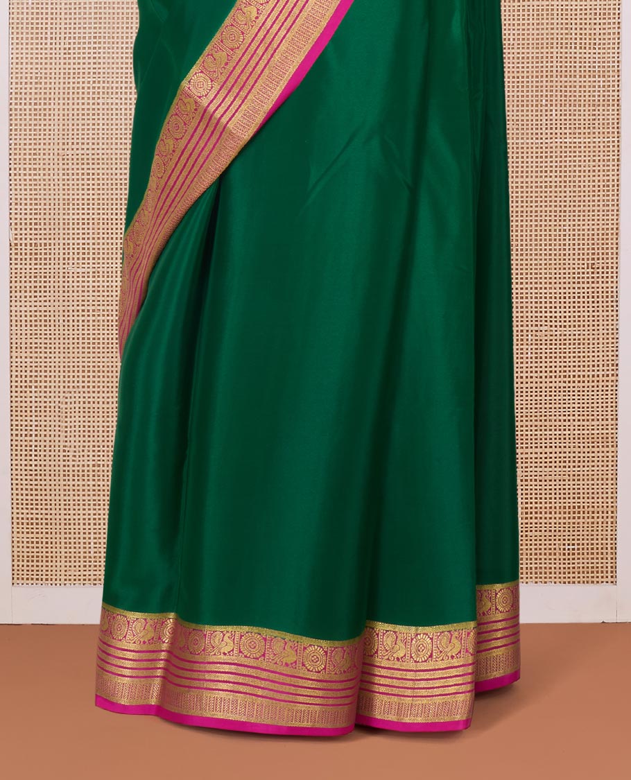 Green plain Mysore silk saree, contrast Peacock and chakram border, and pallu of traditional zari designs