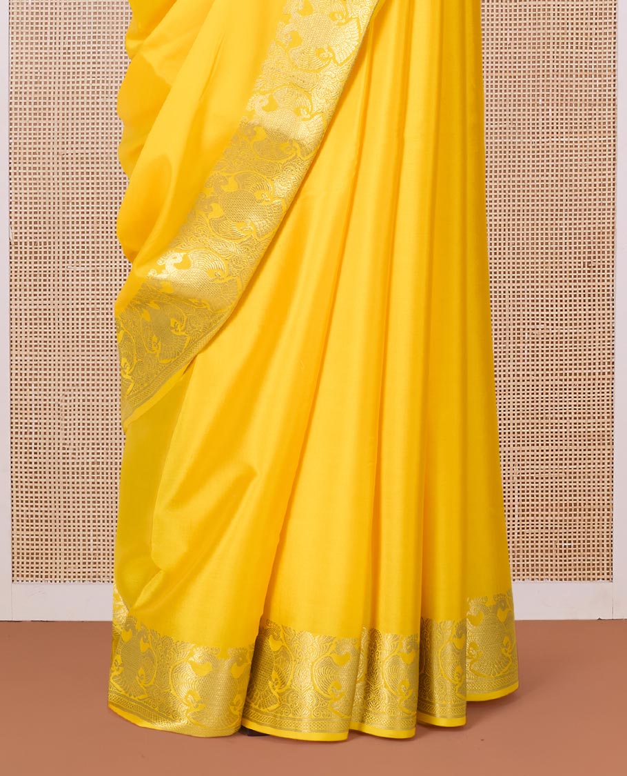 Yellow plain Mysore silk saree, two-headed eagle zari border, and pallu steeped with two-headed eagle motifs