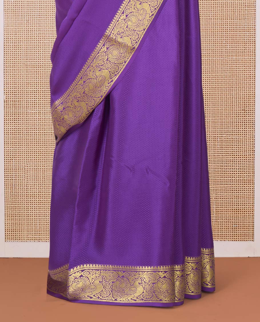 Purple embossed Mysore silk saree, traditional peacock motifs zari woven border, and pallu of traditional designs